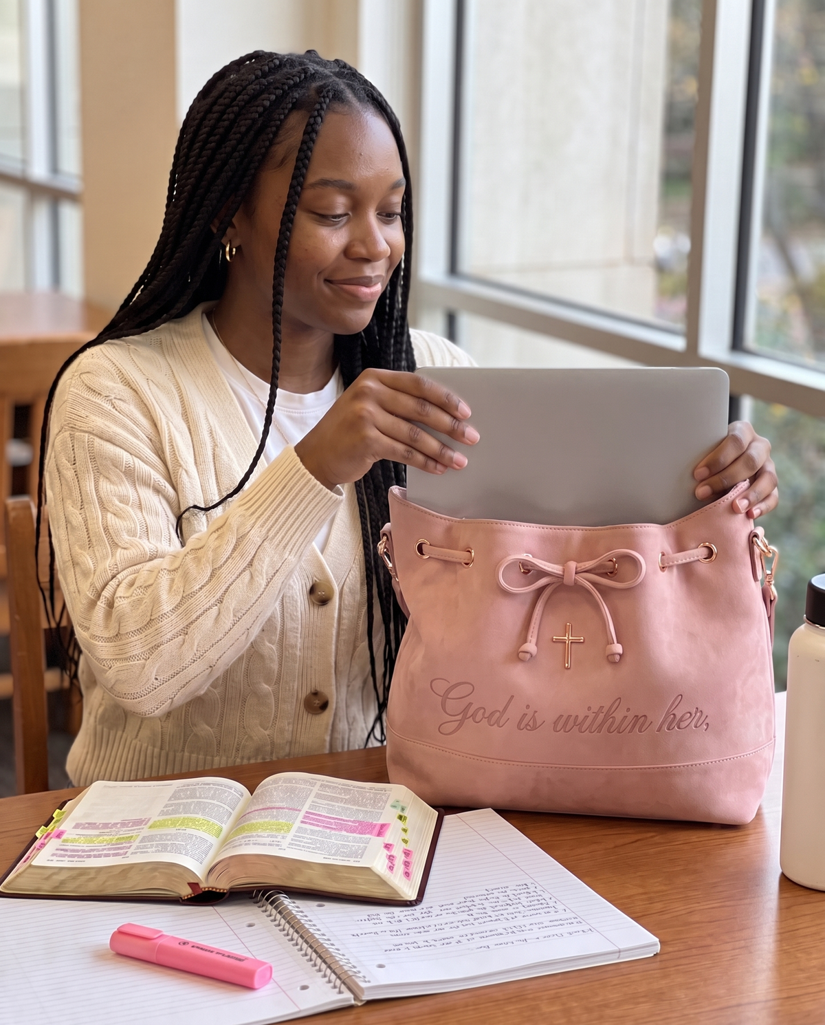 A 14-inch laptop sliding flat into the bag at a library table