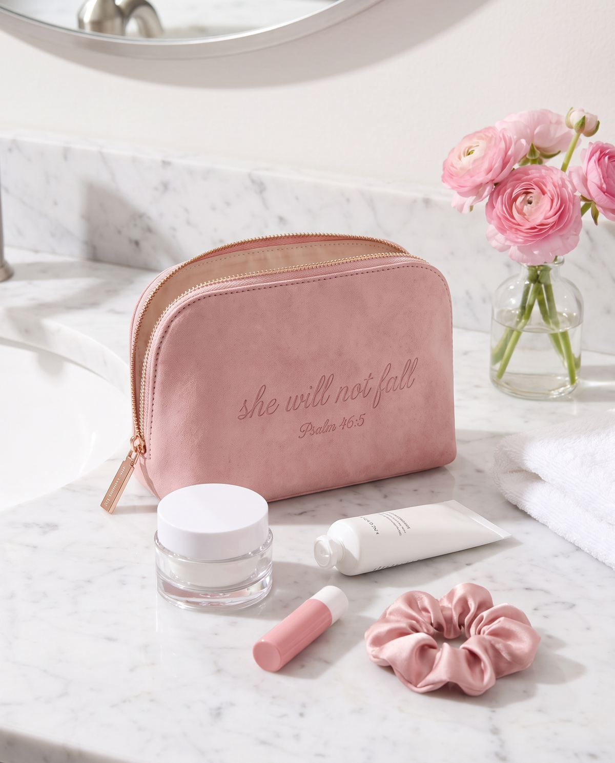 The 46:5 Pouch on a marble bathroom counter with skincare and a scrunchie